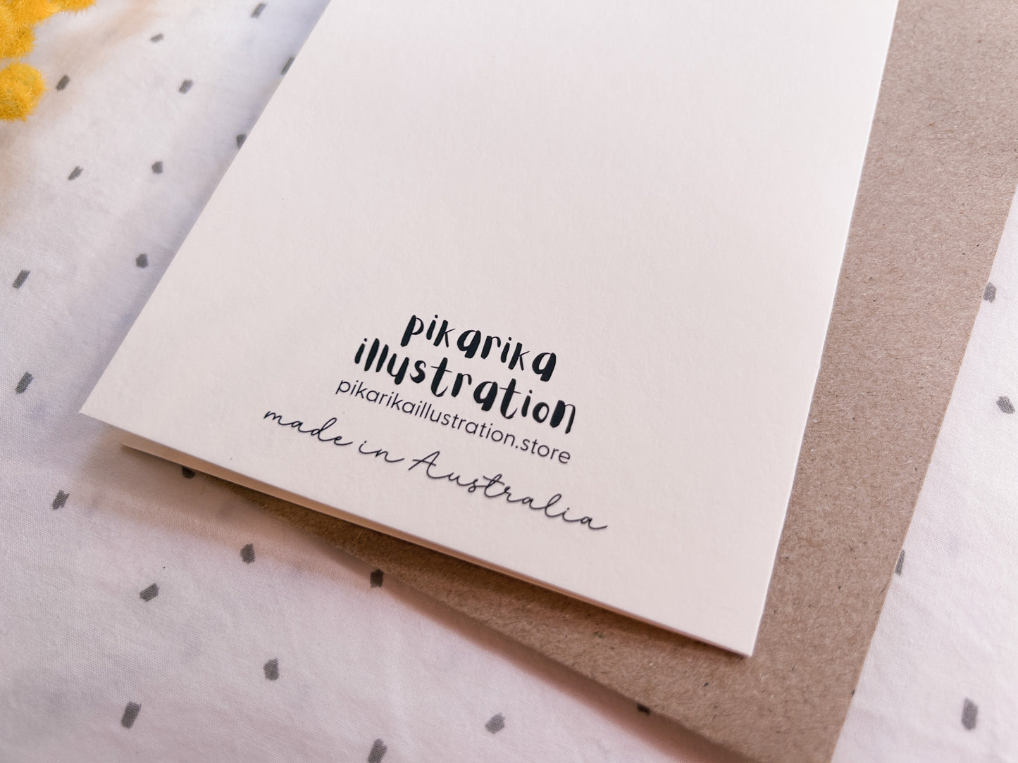 Close up of the back of Illustrated kangaroo greeting card holding a wattle branch, hand-drawn Australian wildlife stationery