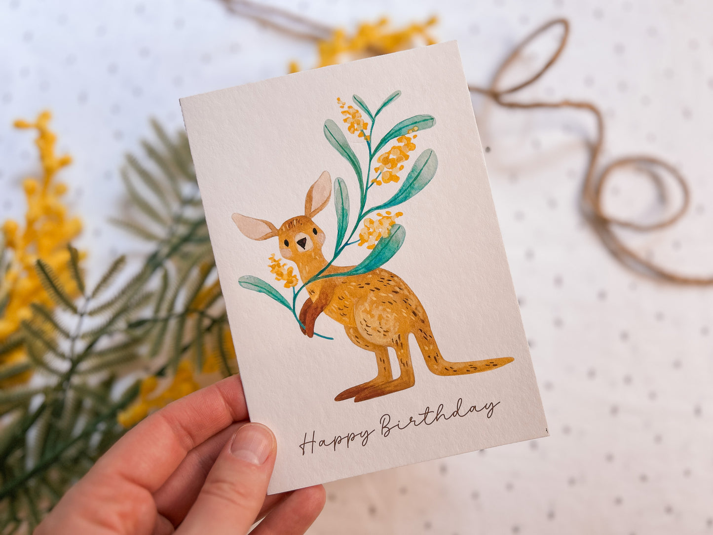 Holding an Illustrated kangaroo greeting card , hand-drawn Australian wildlife stationery by Pikarika Illustration